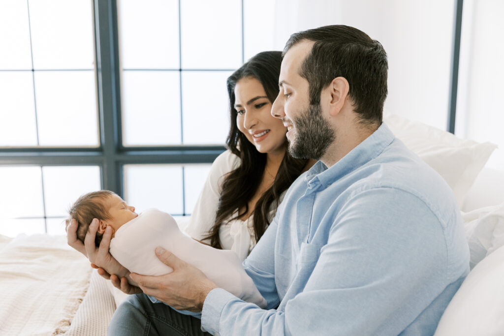 First-time parents holding newborn baby during Scottsdale lifestyle session