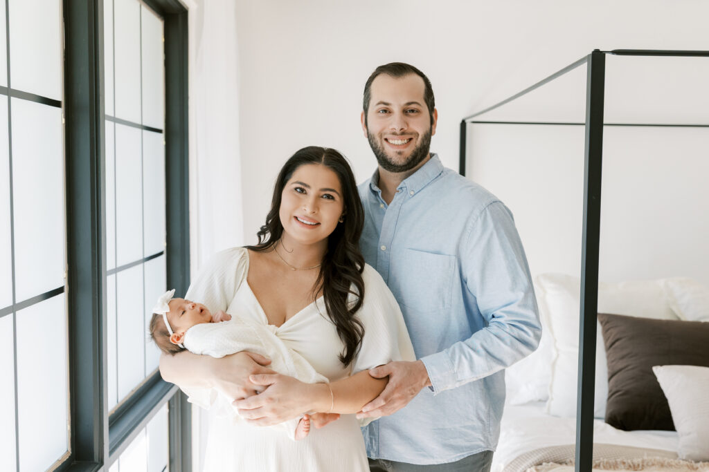 First-time parents holding newborn baby during Scottsdale lifestyle photography session