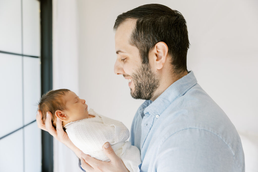 Father holding newborn at The Light Loft studio