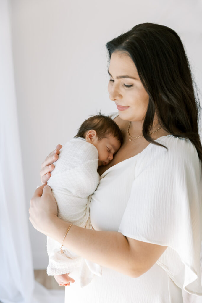 Mother cradling newborn at The Light Loft studio in Scottsdale
