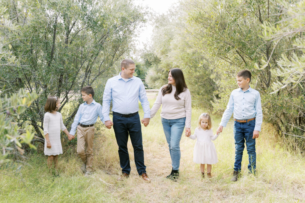 Family holding hands during a Gilbert, Arizona photography mini session