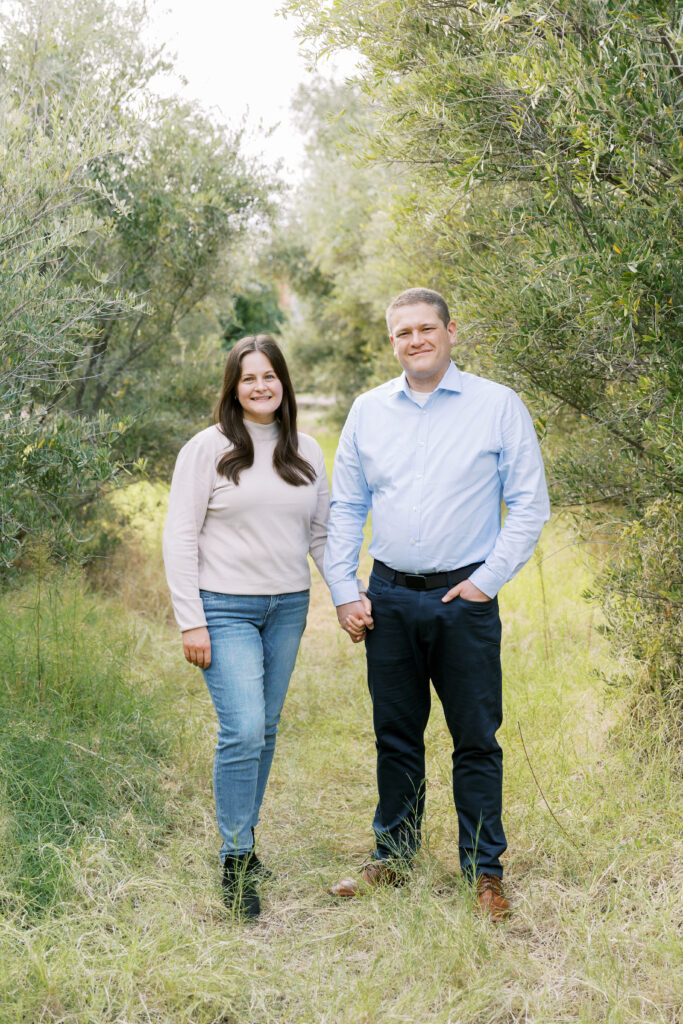 Couple holding hands during family photos